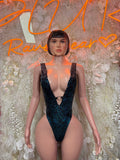 Front view of dark blue glitter plunge bodysuit with V-neck and wide straps