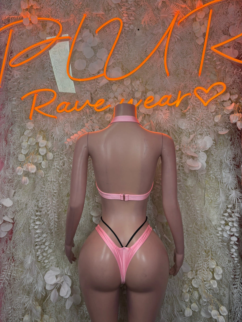 Pink strappy cutout bodysuit with open back and thin crisscross straps