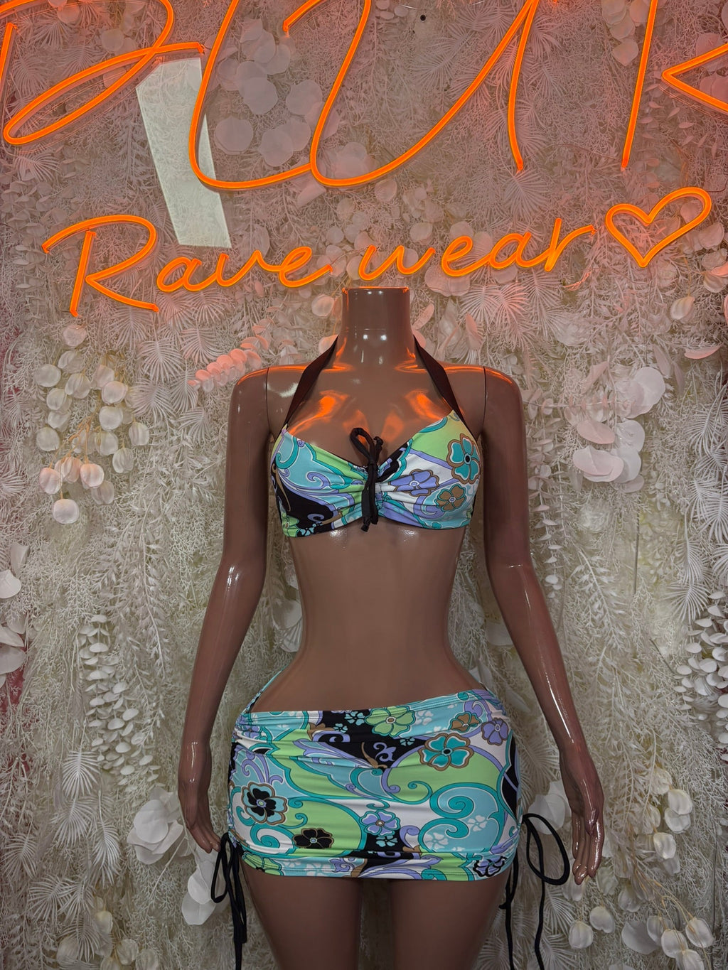 Two-piece festival outfit: halter bikini top and mini skirt, colorful graphic print
