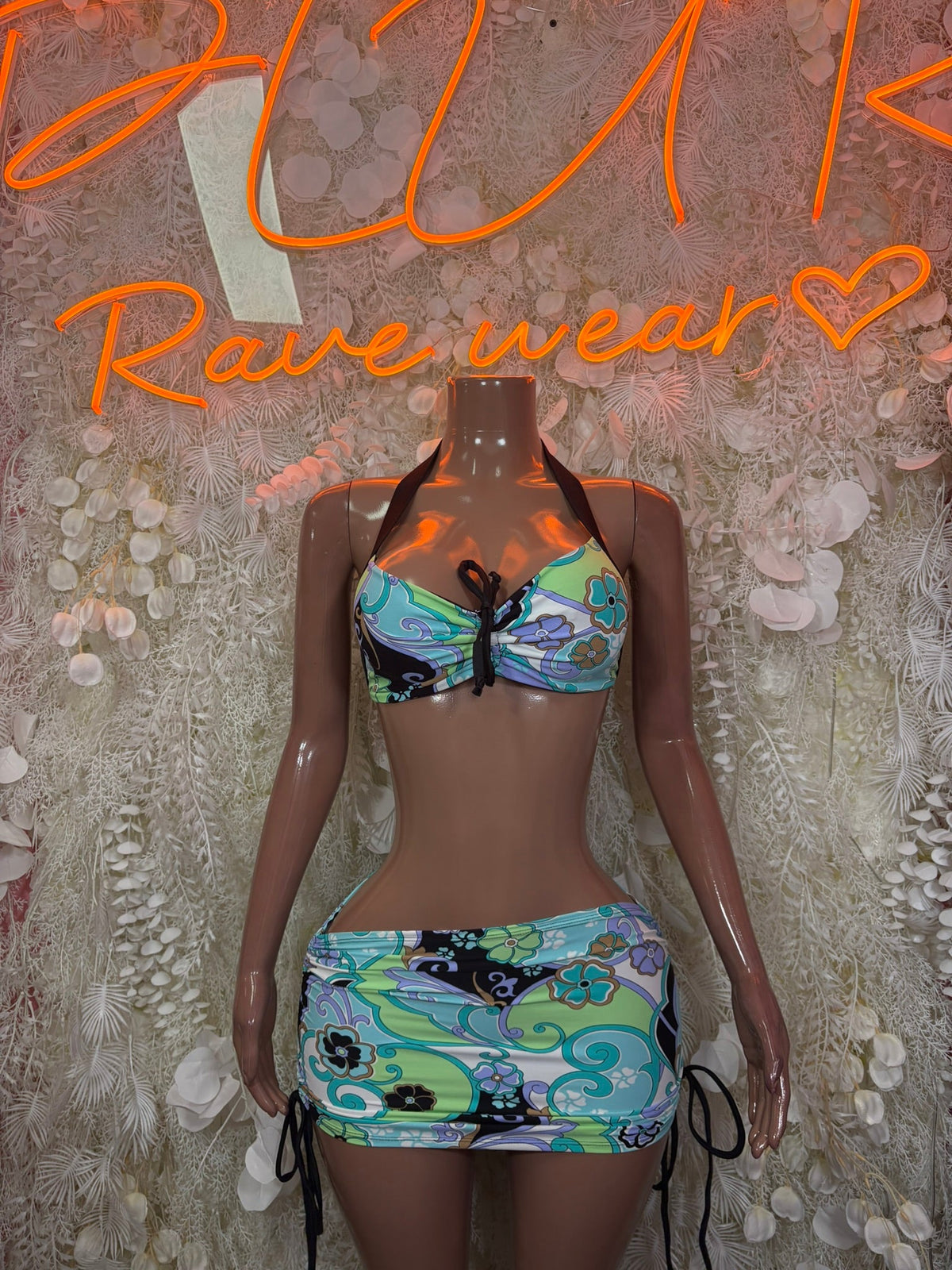 Two-piece festival outfit: halter bikini top and mini skirt, colorful graphic print