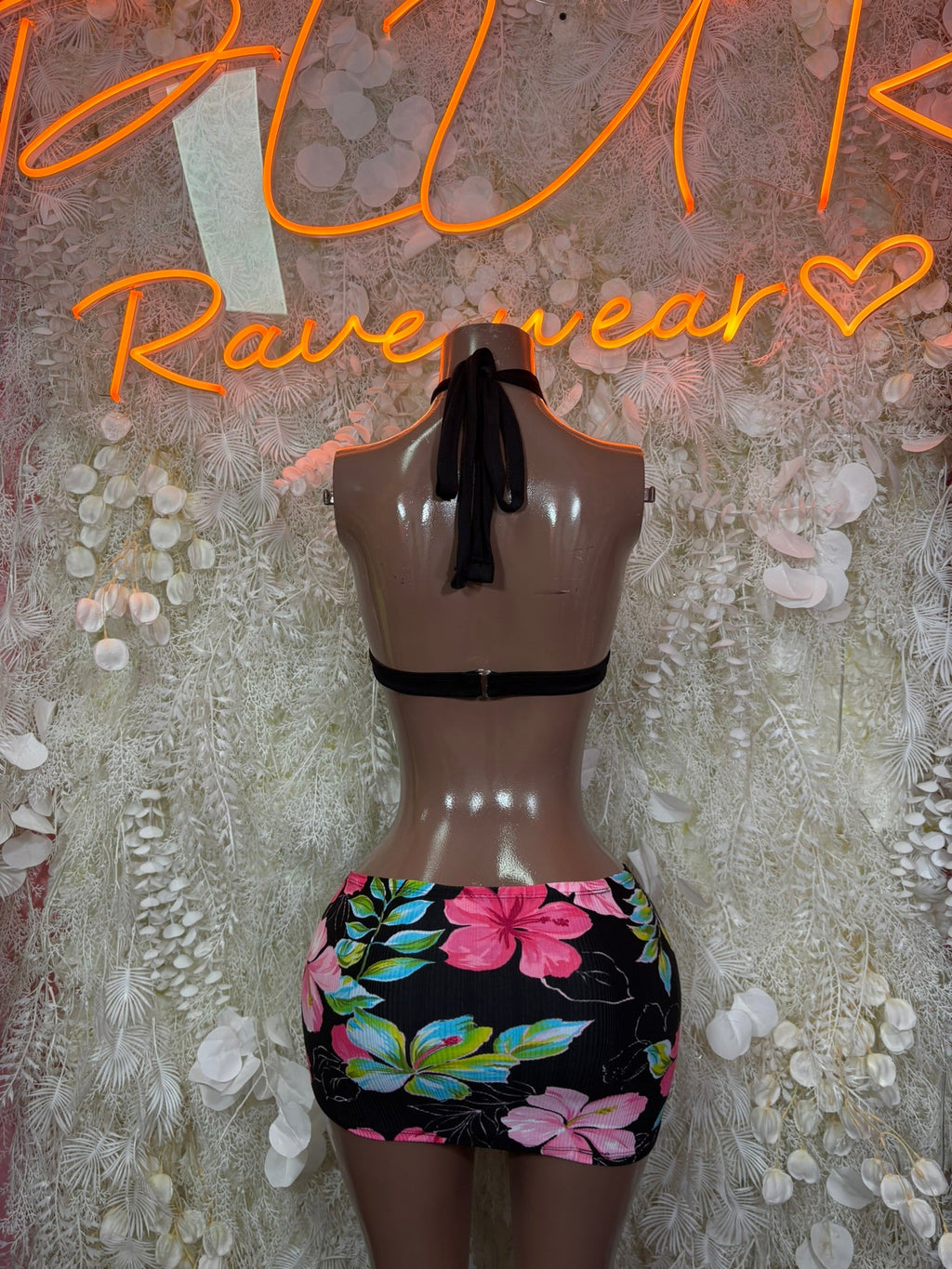 Backless black halter top with tie straps and floral mini skirt