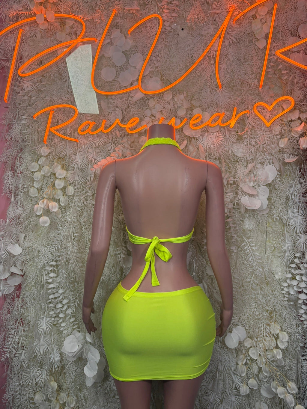 Back view neon lime ruched mini skirt set with tie-back halter bralette