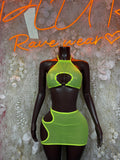 Neon green halter cutout mini dress set with matching mini skirt on mannequin