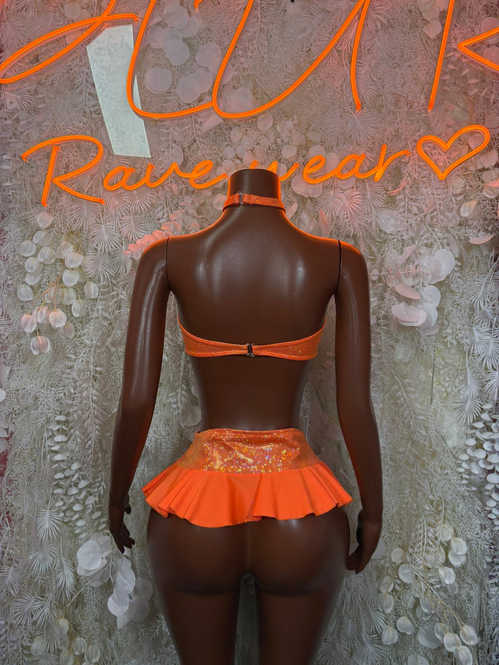 Orange backless bandeau top with ruffle mini skirt, back view