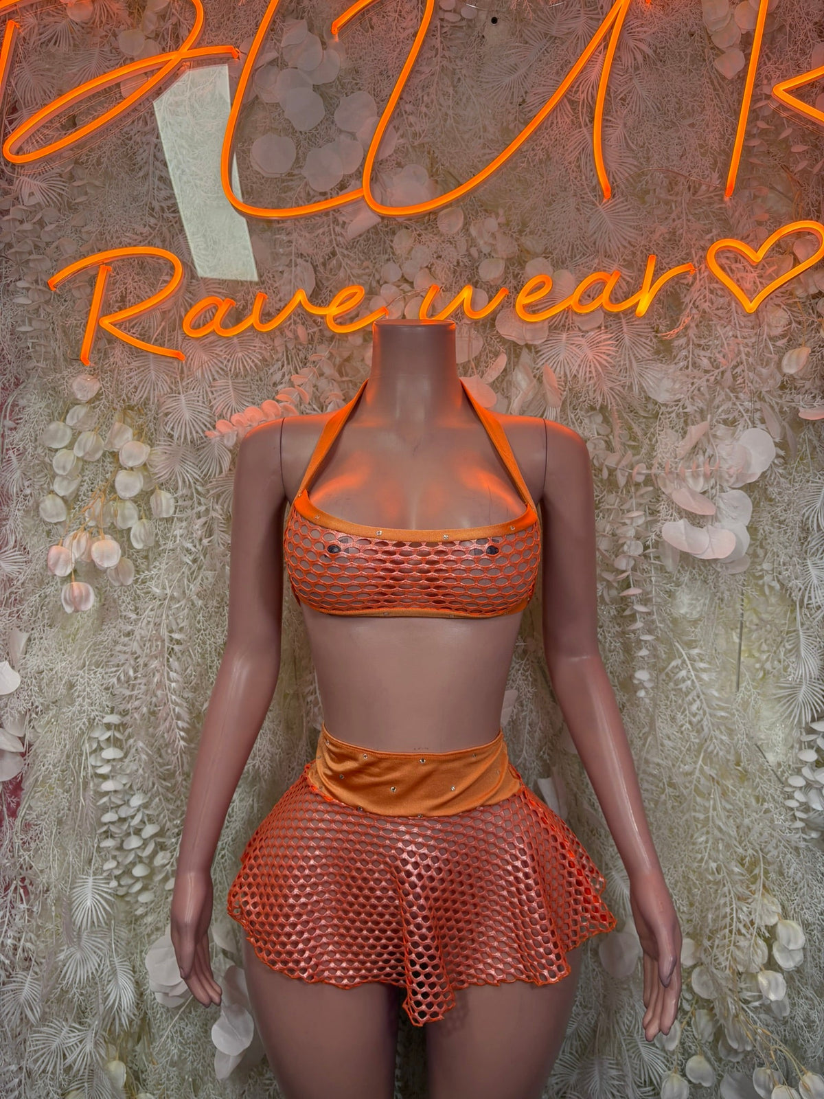 Orange halter bikini top with polka-dot mesh shorts skirt, front view