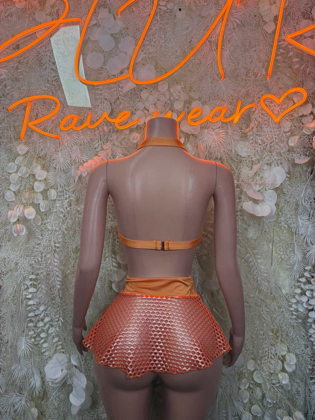 Orange halter bikini top and flared polka-dot mesh skirt, back view
