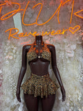 Leopard halter crop top and ruffle mini skirt set on a mannequin
