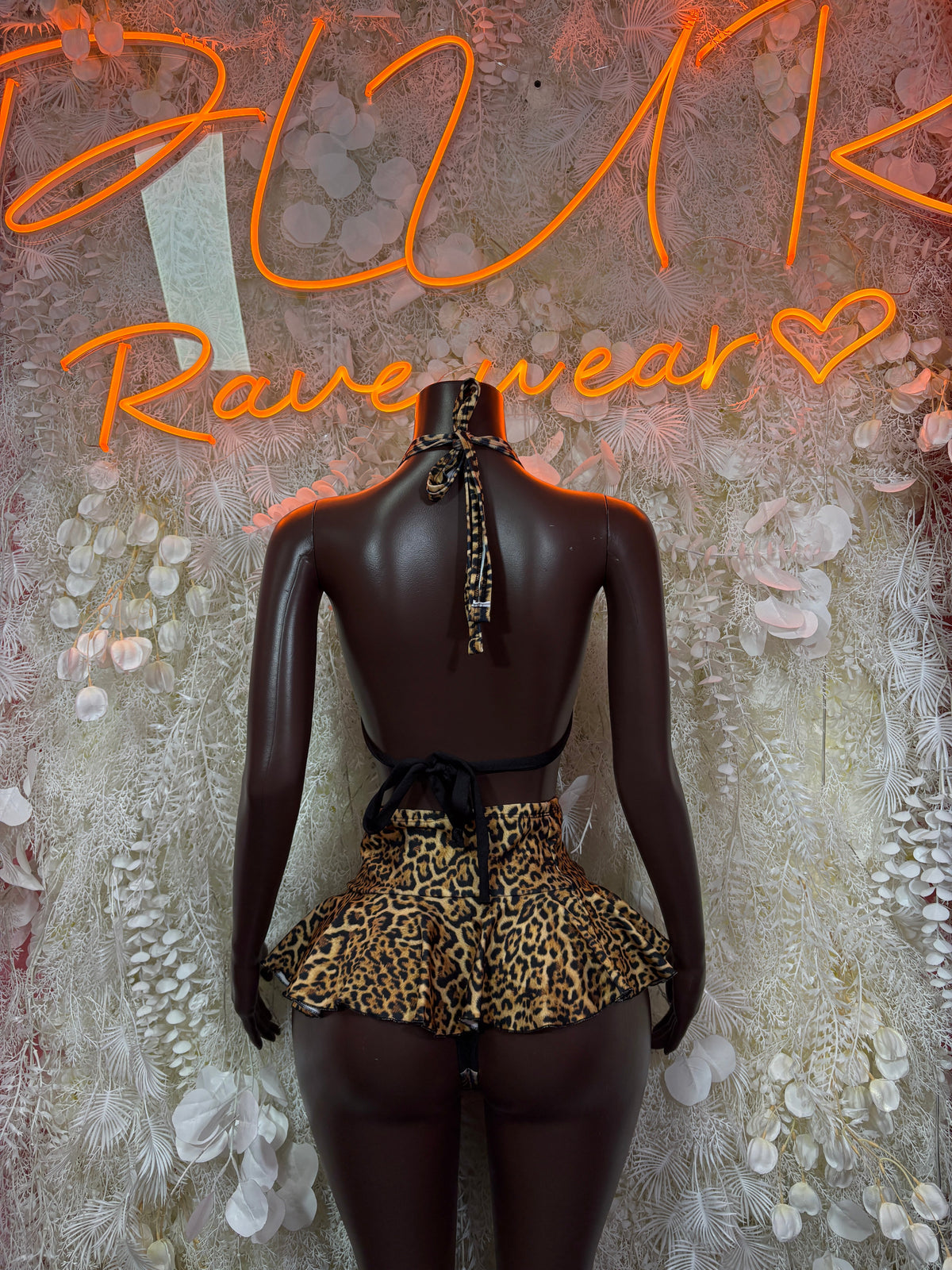 Back view: leopard halter top with tie straps and ruffle mini skirt