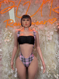 Black bandeau bikini top with purple plaid strappy high-cut bottoms