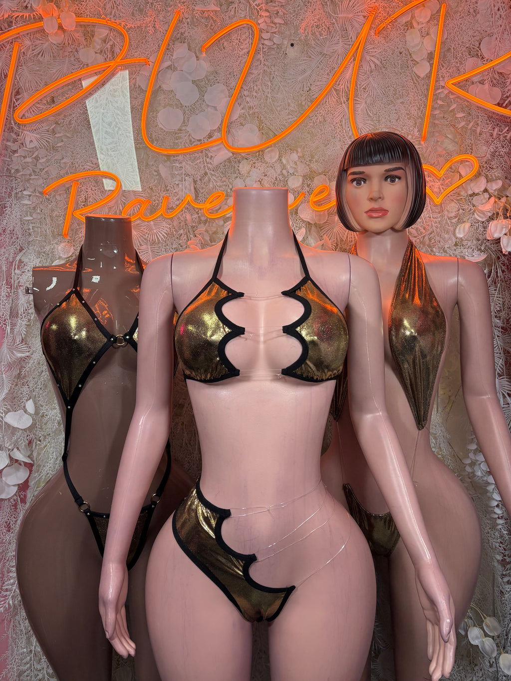 Gold-and-black strappy bikini set with halter triangle top and matching thong bottom