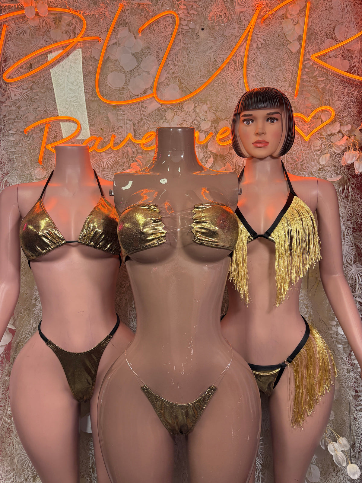 Black cutout bodysuit with gold sequin cups and gold fringe, worn by model