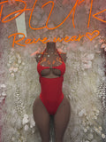 Red strappy cutout bodysuit with halter neckline and front chest cutouts